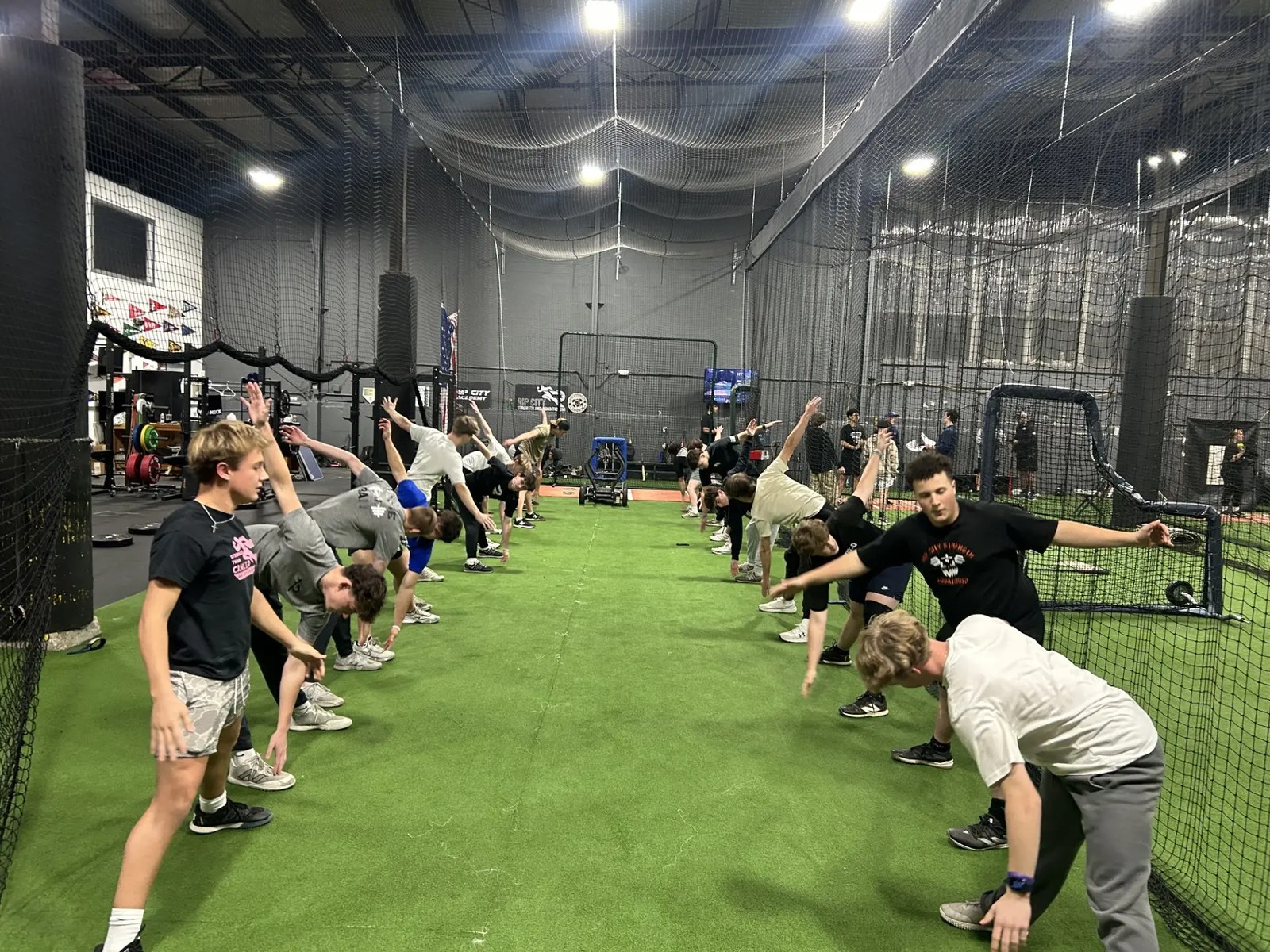 Rip City athletes warming up in a line on the indoor turf